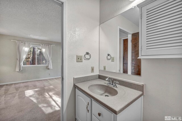 bathroom featuring vanity and a textured ceiling