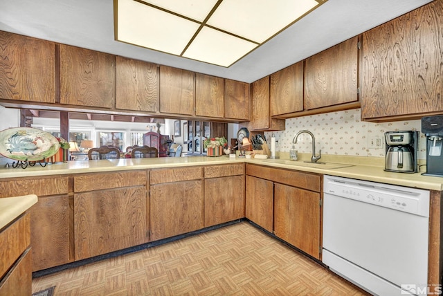 kitchen featuring dishwasher, light parquet floors, and sink