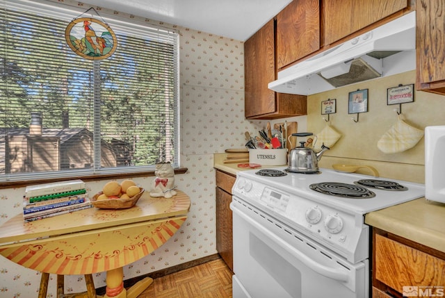 kitchen featuring electric range, light parquet floors, and plenty of natural light