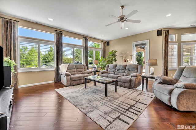 living room with dark hardwood / wood-style floors, plenty of natural light, and ceiling fan