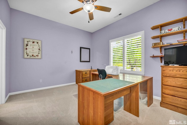 home office featuring ceiling fan and light carpet