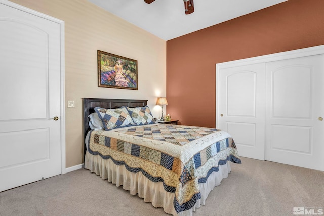 carpeted bedroom with a closet and ceiling fan