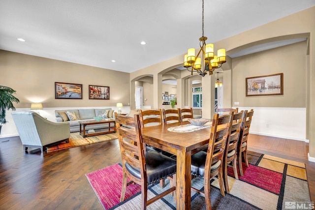 dining space featuring a chandelier and dark wood-type flooring