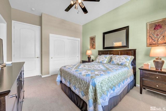 carpeted bedroom featuring ceiling fan and a closet