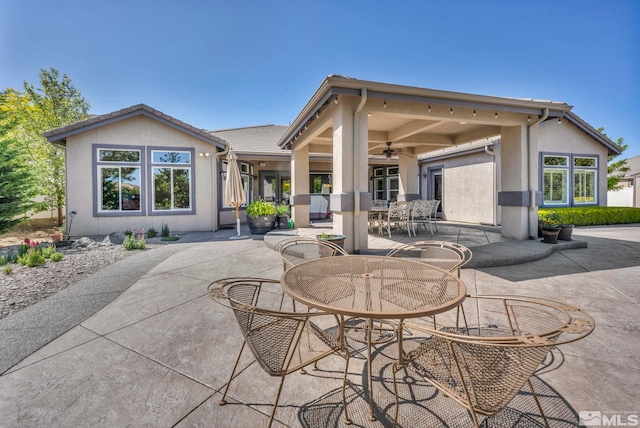 back of property featuring a patio and ceiling fan