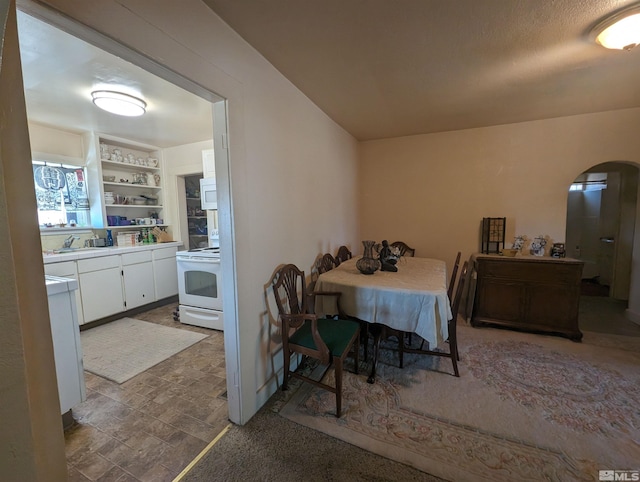 dining room featuring sink, built in features, and tile floors