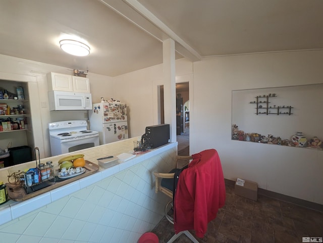 kitchen with dark tile flooring, white appliances, white cabinetry, and tile counters