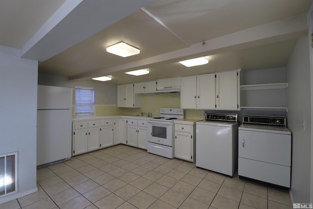 kitchen featuring independent washer and dryer, light tile flooring, white cabinetry, sink, and white appliances