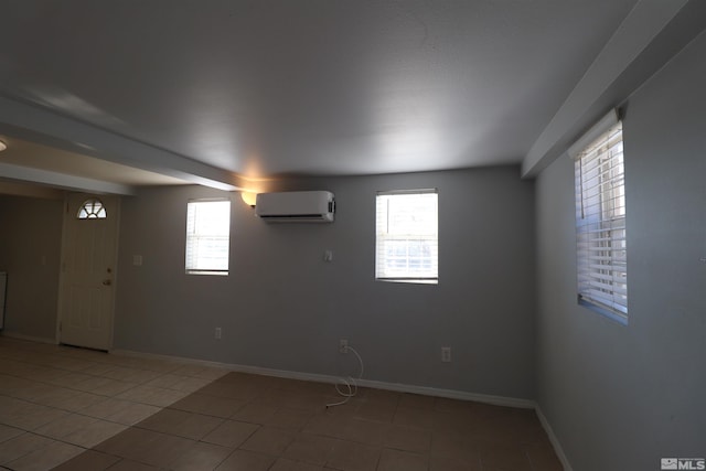 tiled spare room featuring a wall mounted air conditioner