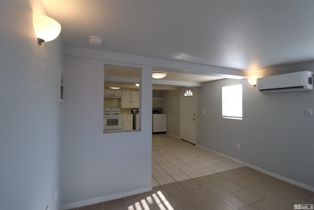 basement featuring light tile floors and an AC wall unit