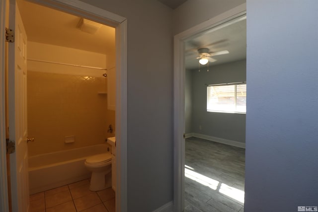 full bathroom with ceiling fan, toilet, bathtub / shower combination, tile flooring, and vanity