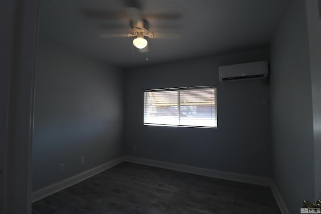 spare room with dark hardwood / wood-style floors, a wall unit AC, and ceiling fan