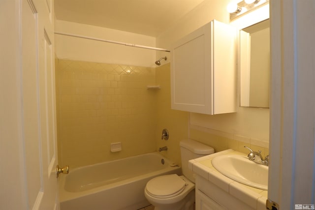 full bathroom with vanity with extensive cabinet space, toilet, and tiled shower / bath combo