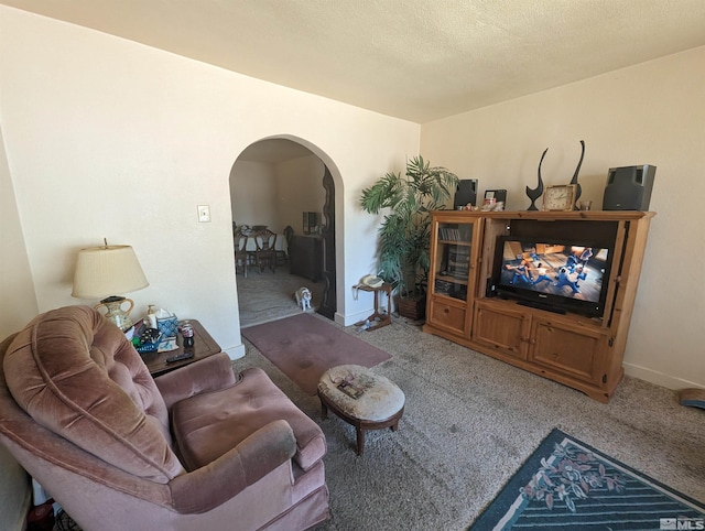 living room featuring a textured ceiling and carpet floors