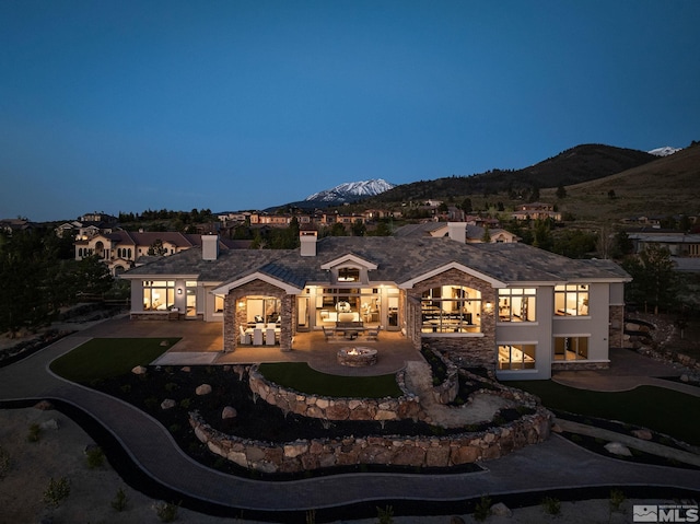 view of front of home featuring a mountain view and a patio