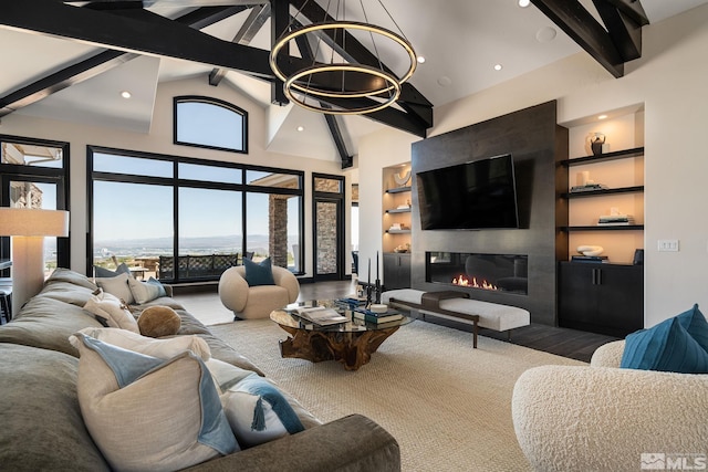 living room with high vaulted ceiling, a large fireplace, beam ceiling, and built in shelves