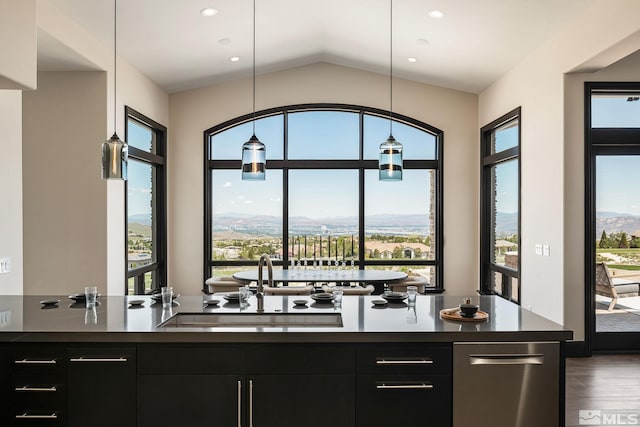 interior space with vaulted ceiling, hardwood / wood-style floors, a wealth of natural light, and pendant lighting