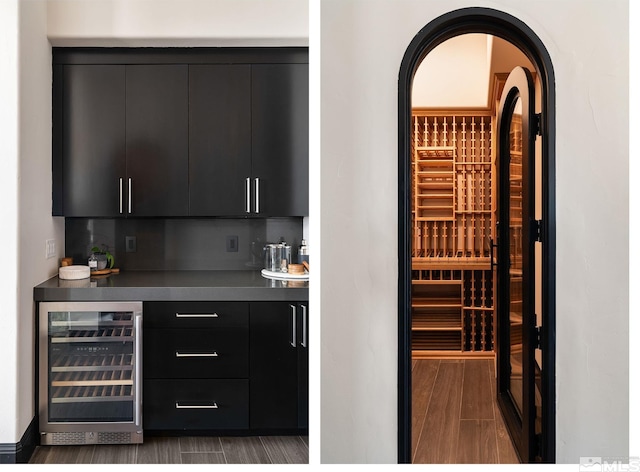 wine cellar with indoor bar, wine cooler, and dark hardwood / wood-style flooring