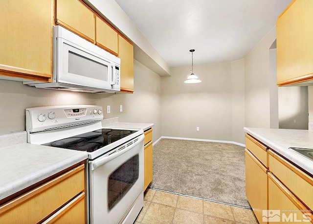 kitchen featuring light carpet, white appliances, and pendant lighting