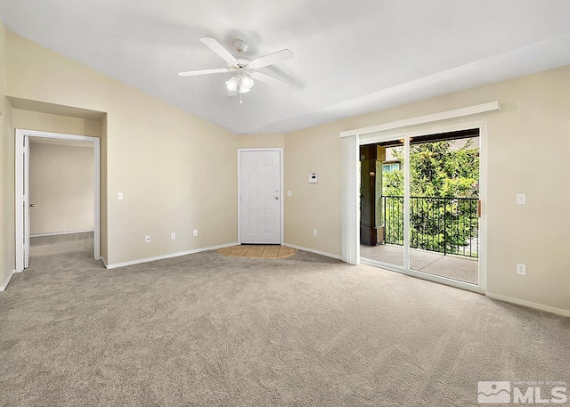 empty room featuring carpet floors, ceiling fan, and vaulted ceiling