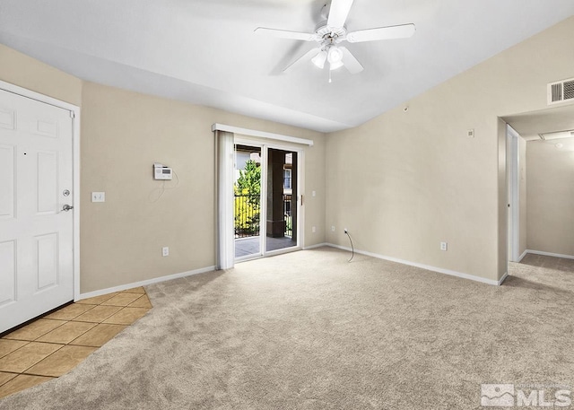 empty room with tile floors, ceiling fan, and lofted ceiling