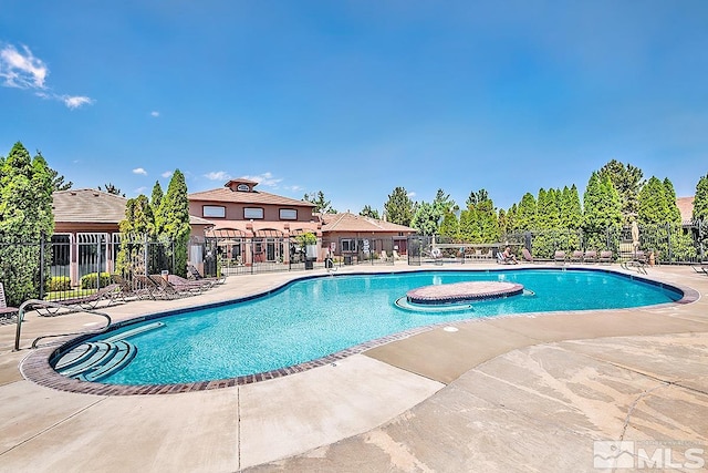 view of swimming pool featuring a patio area