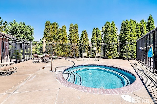 view of swimming pool featuring a patio and a community hot tub