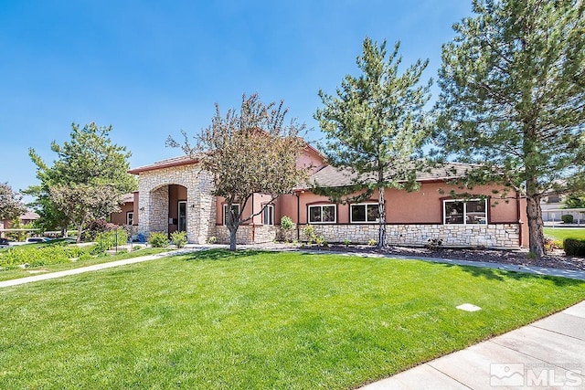 mediterranean / spanish home featuring a front lawn