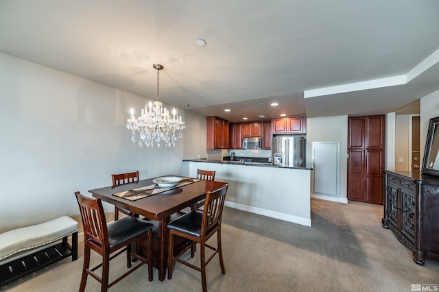 carpeted dining area with an inviting chandelier