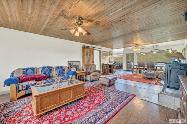 living room with a barn door, wooden ceiling, hardwood / wood-style flooring, and ceiling fan