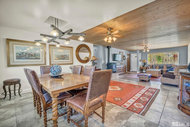 dining area featuring light tile flooring, ceiling fan, and wood ceiling