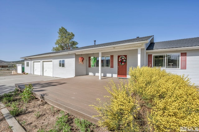 ranch-style house featuring a garage and a deck