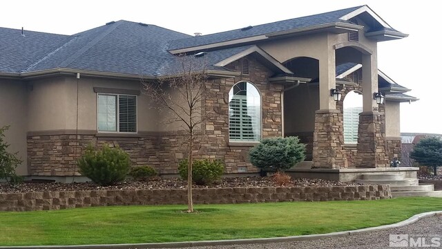 view of side of property with a yard