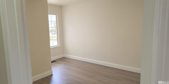 empty room with hardwood / wood-style floors