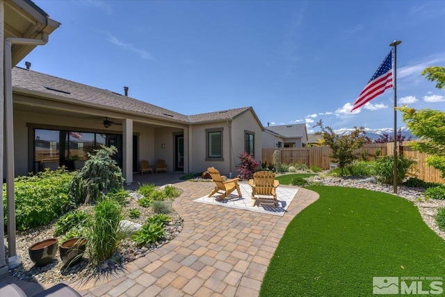 view of yard with ceiling fan and a patio