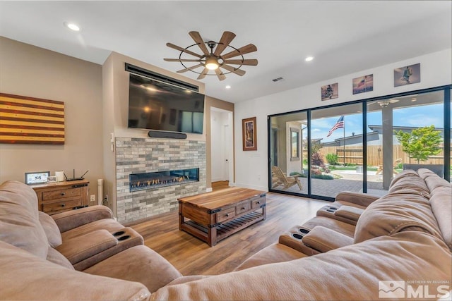 living room featuring light hardwood / wood-style flooring and ceiling fan