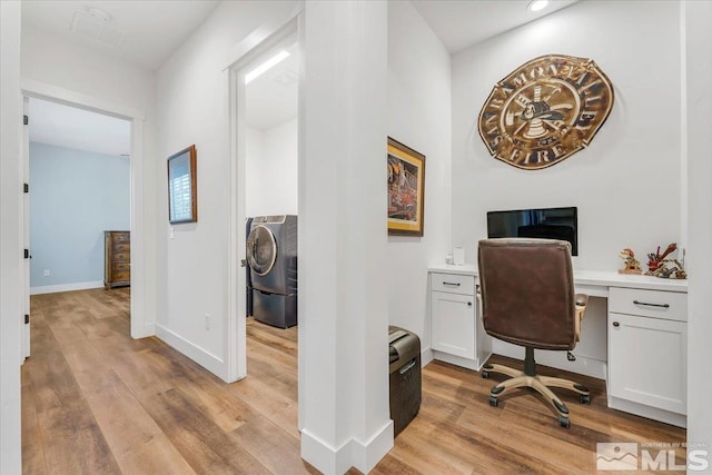 office space with washer / dryer and light wood-type flooring