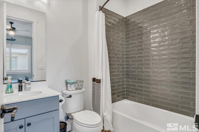 full bathroom with shower / bath combination with curtain, vanity, toilet, and ceiling fan