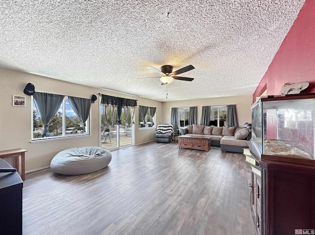 living room with hardwood / wood-style floors, a textured ceiling, and ceiling fan