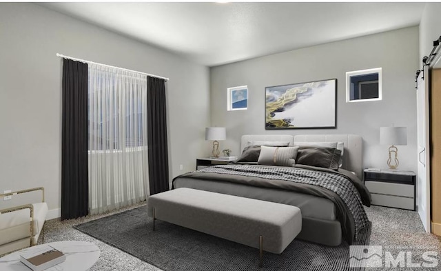 bedroom featuring a barn door and carpet