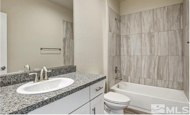 full bathroom with vanity, toilet, and tiled shower / bath