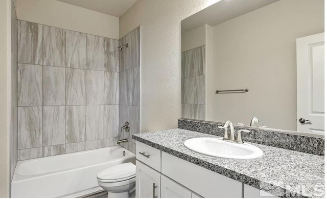 full bathroom with vanity, toilet, and tiled shower / bath