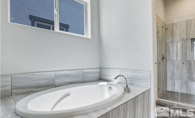 bathroom featuring separate shower and tub