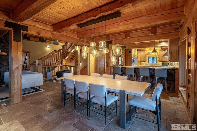 dining room with beam ceiling and wooden ceiling