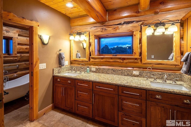 bathroom with rustic walls, vanity, a washtub, wooden ceiling, and beam ceiling