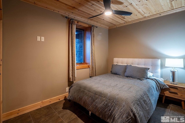 bedroom with ceiling fan, wooden ceiling, and dark tile patterned floors