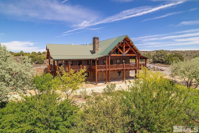 rear view of property with a wooden deck