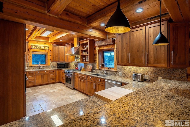 kitchen with wall chimney exhaust hood, sink, appliances with stainless steel finishes, kitchen peninsula, and pendant lighting