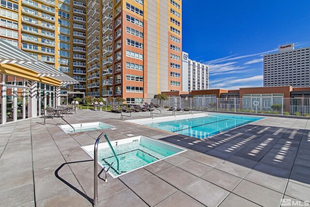 view of swimming pool featuring a community hot tub