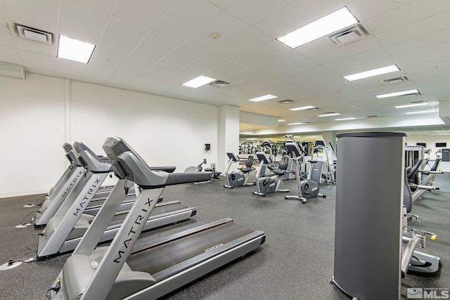 workout area with a drop ceiling and visible vents